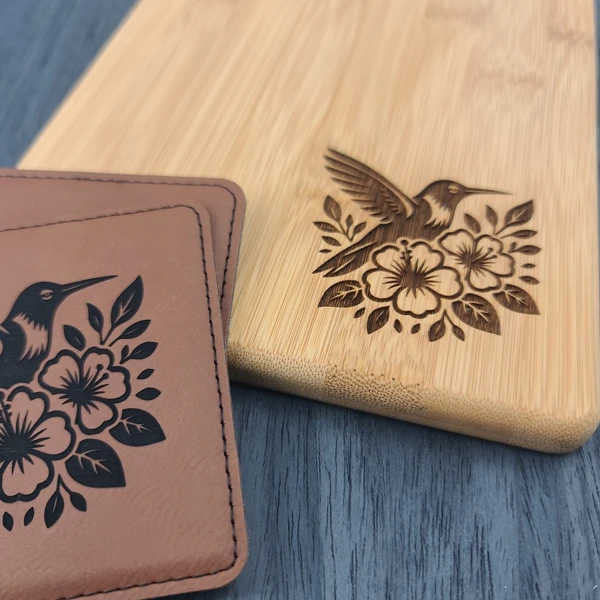 Hummingbird and flower designs engraved on a wooden board and a stitched leather piece