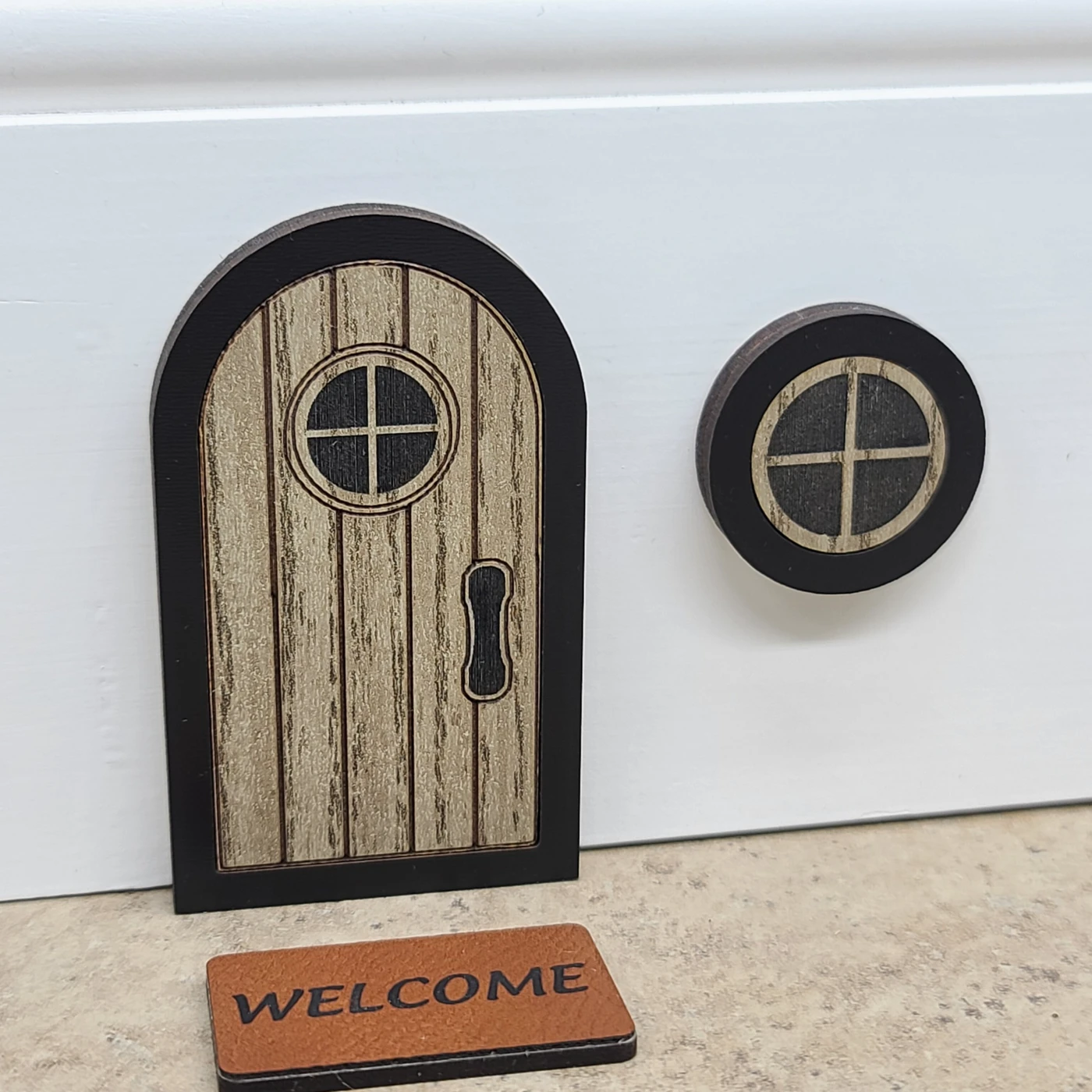 Miniature wooden mouse door, round window, and Welcome doormat