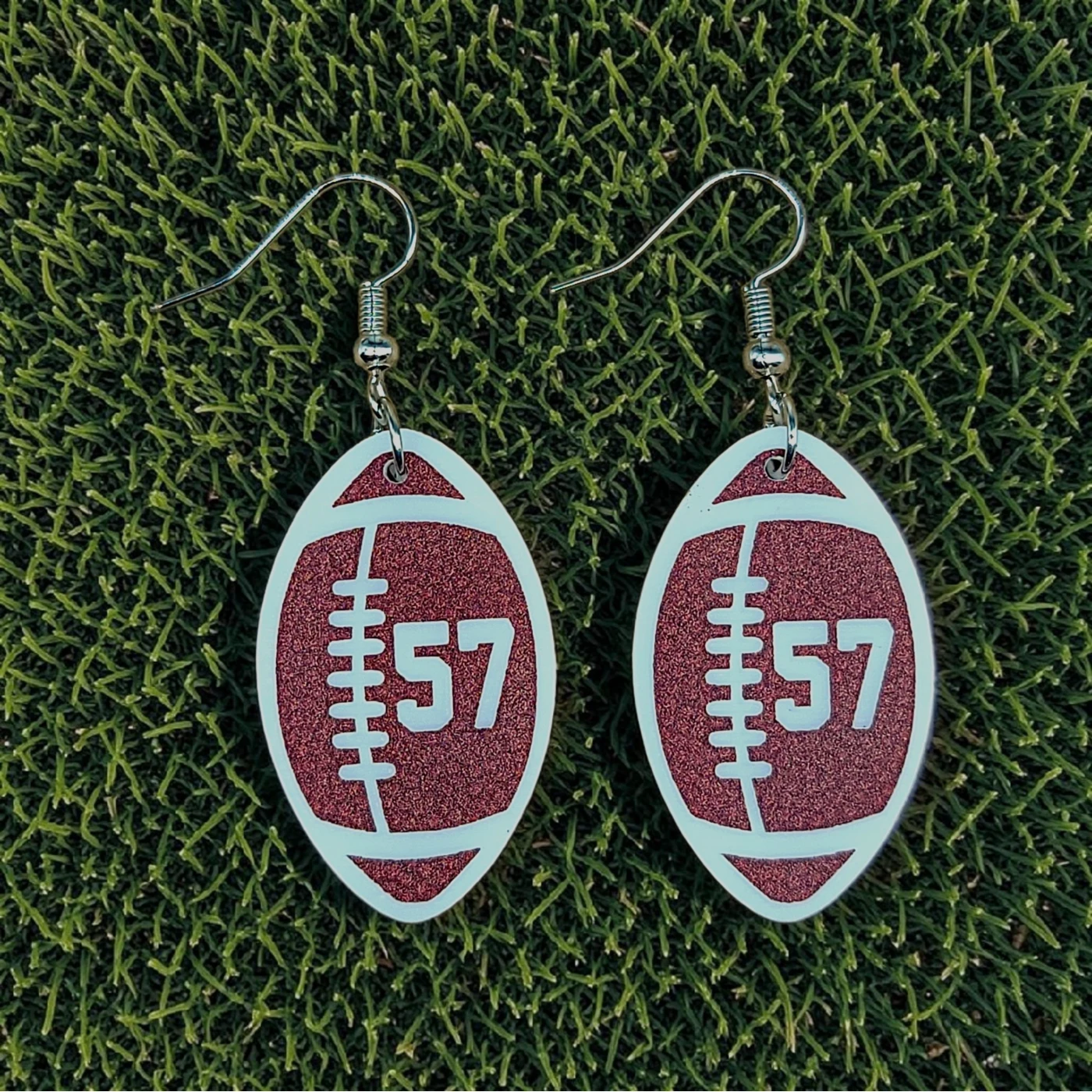 Red and white football earrings with number 57