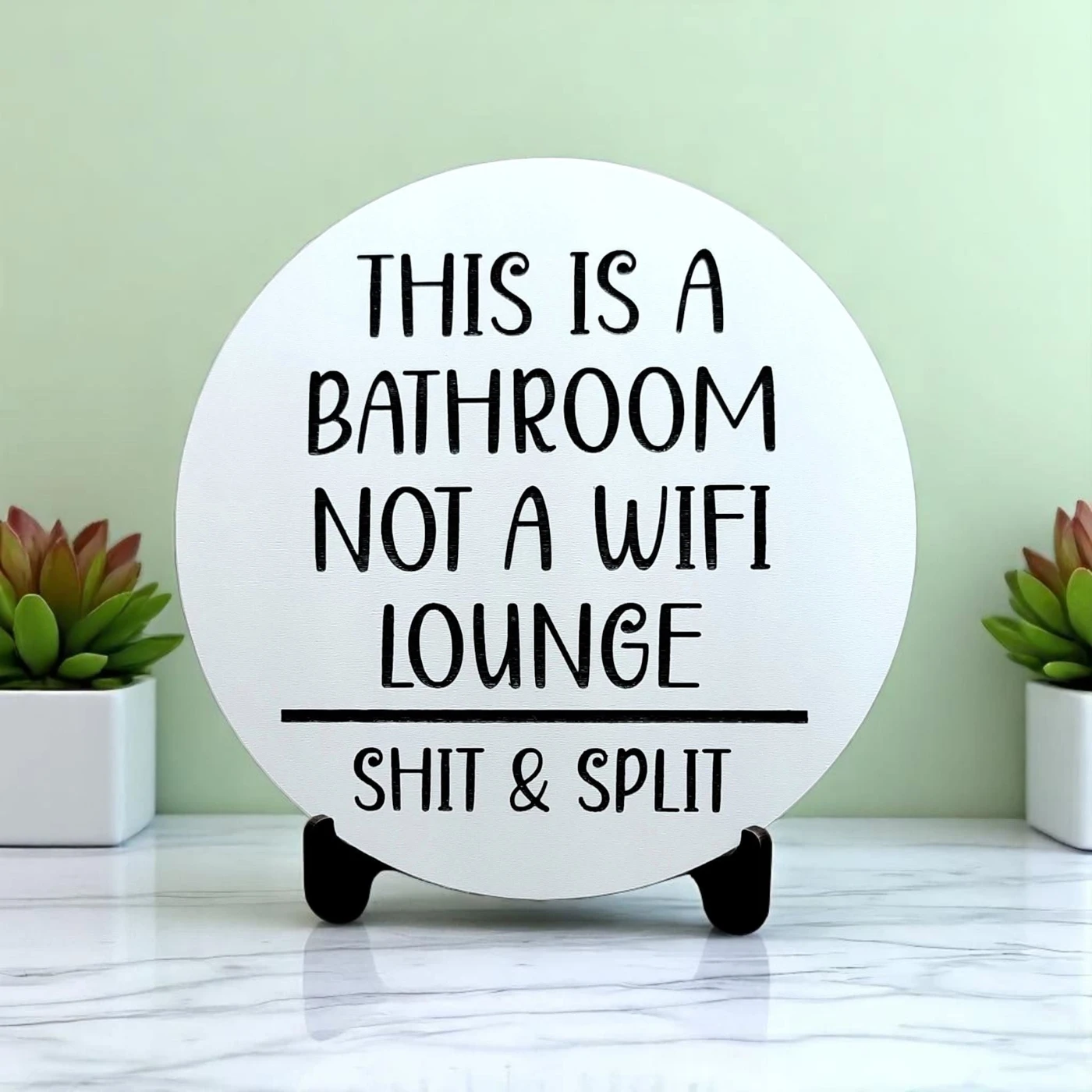 Round bathroom humor sign reading This is a bathroom, not a WiFi lounge