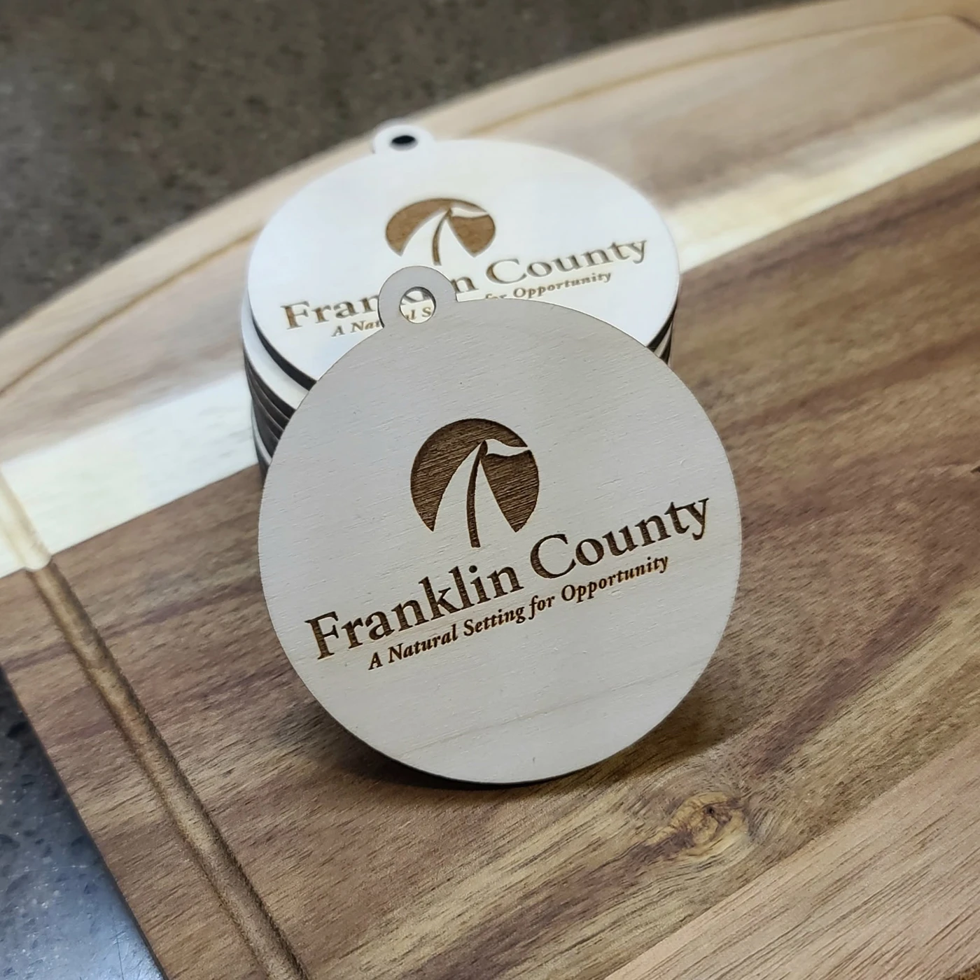 Round coasters engraved with the Franklin County Animal Hospital logo
