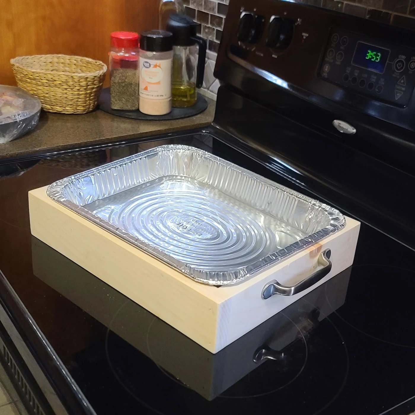 Wooden serving tray holding a foil baking pan