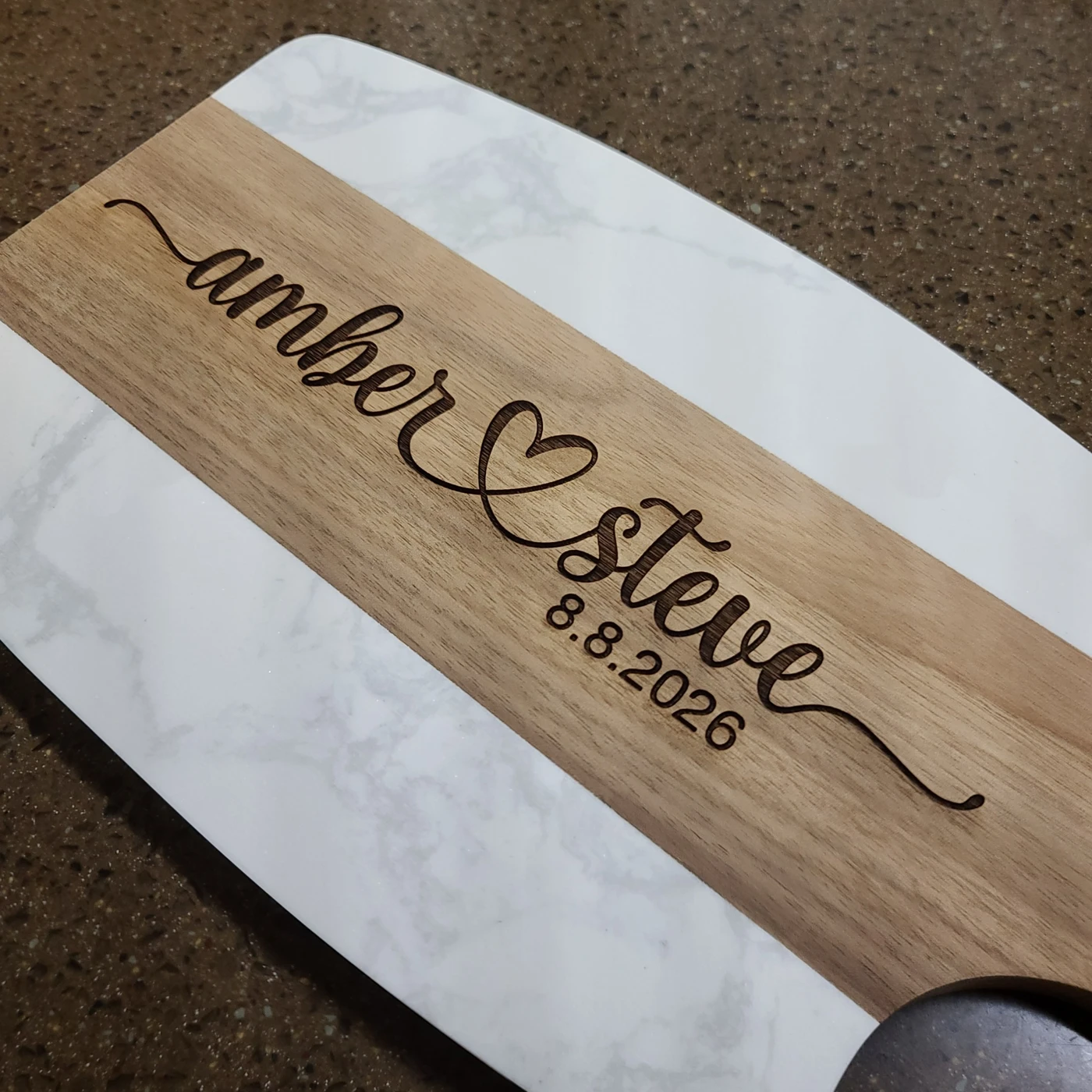 Wood and marble board engraved Amber and Steve with their wedding date