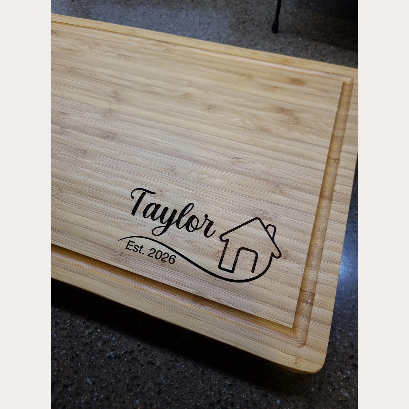 Wooden board engraved Taylor, a house outline, and Est. 2026