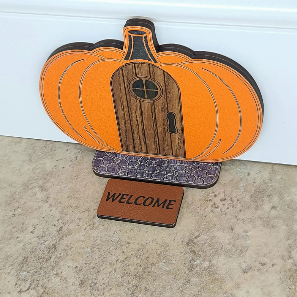 Finished pumpkin-shaped miniature mouse door with stone-look step and Welcome mat