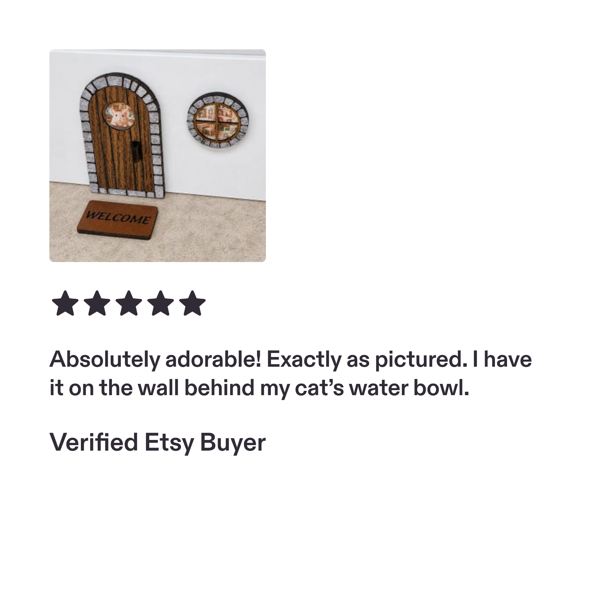 Miniature arched wooden door with stone-look frame, round window and Welcome mat.